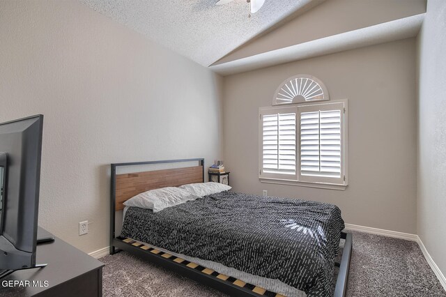 carpeted bedroom with a textured ceiling, ceiling fan, and lofted ceiling