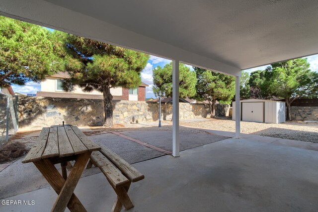 view of patio / terrace featuring a storage unit