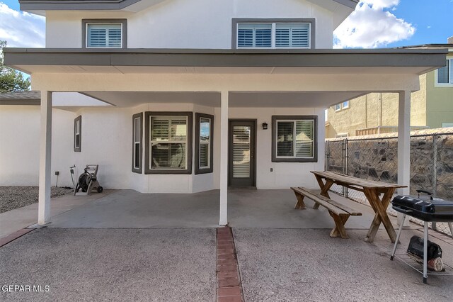 rear view of property featuring a patio area