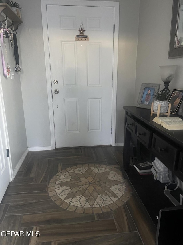 foyer entrance with dark hardwood / wood-style flooring