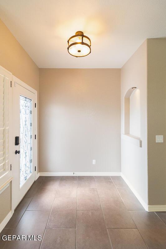 interior space with dark tile patterned flooring