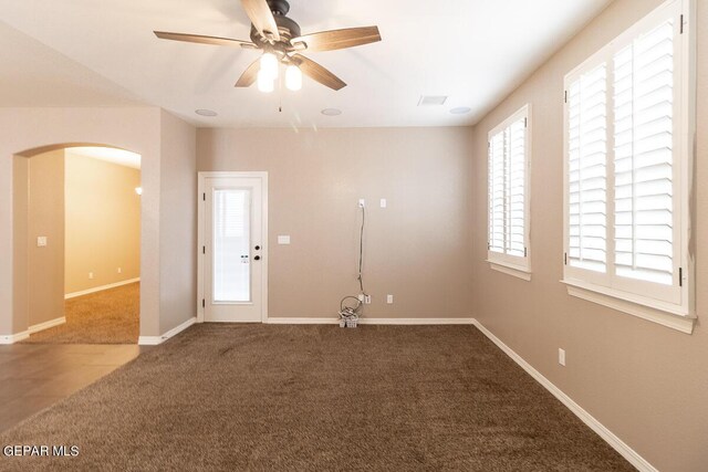 unfurnished room featuring ceiling fan and carpet floors