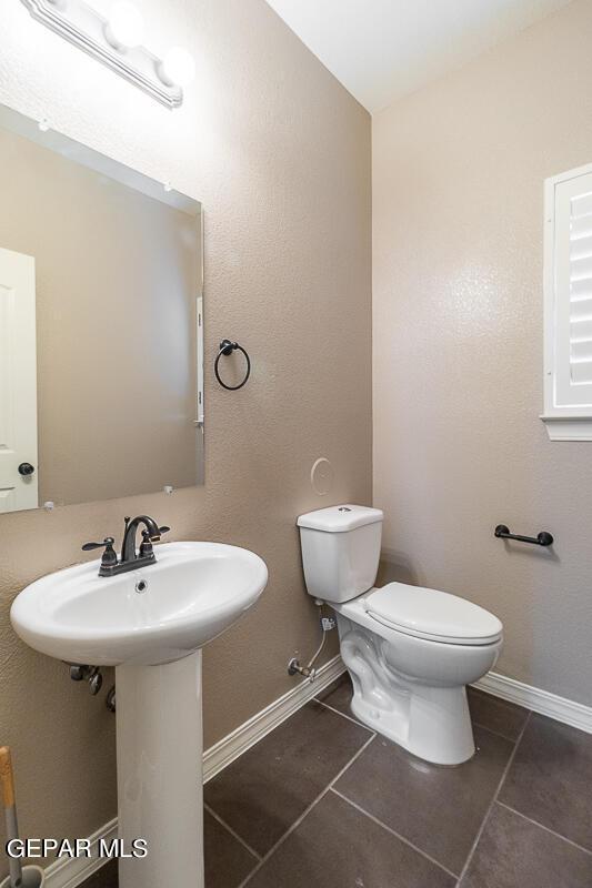 bathroom with tile patterned flooring and toilet