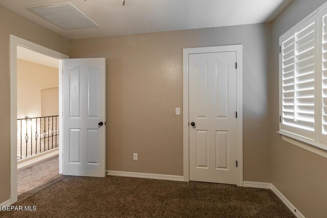 unfurnished bedroom featuring carpet