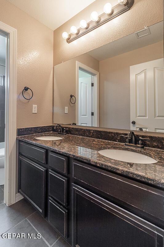 bathroom with tile patterned floors, toilet, and vanity