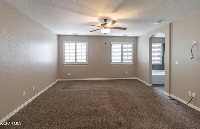 carpeted spare room with a textured ceiling and ceiling fan