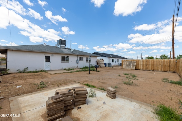 rear view of property featuring cooling unit and a patio