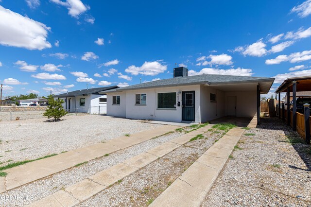 back of house with a carport