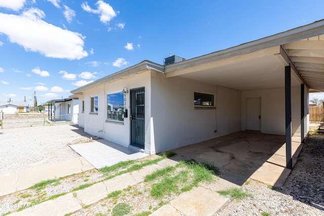 rear view of property with a carport