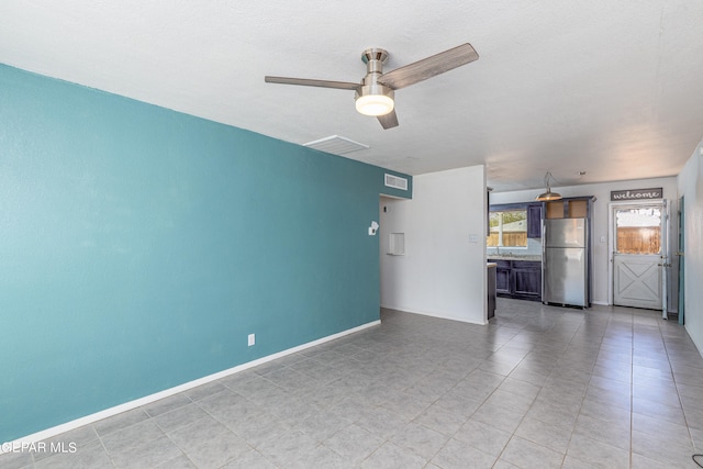 unfurnished living room with ceiling fan and sink