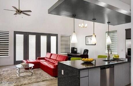 living room featuring light wood-type flooring, sink, and ceiling fan