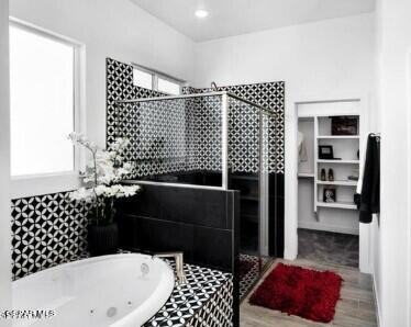 bathroom with wood-type flooring, a wealth of natural light, and separate shower and tub