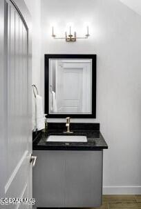 bathroom featuring vaulted ceiling and vanity