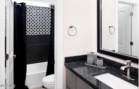 full bathroom with vanity, toilet, and shower / bath combination with curtain