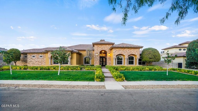 4500 Honey Willow Way, El Paso, TX 79922 - mediterranean / spanish home with a tile roof, a front yard, stucco siding, a chimney, and stone siding