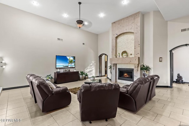 4500 Honey Willow Way, El Paso, TX 79922 - living area featuring a towering ceiling, light tile patterned flooring, a fireplace, baseboards, and recessed lighting