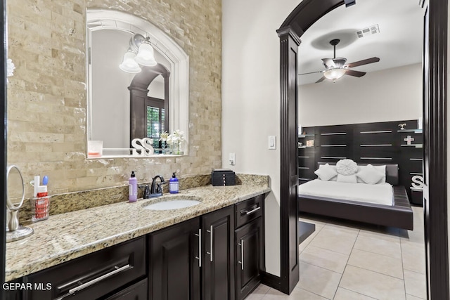 bathroom with decorative backsplash, vanity, ceiling fan, and tile patterned flooring