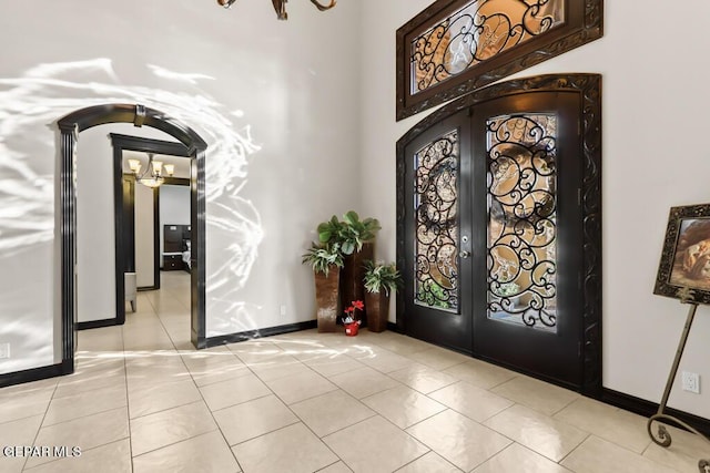 4500 Honey Willow Way, El Paso, TX 79922 - entryway featuring french doors, a chandelier, light tile patterned floors, baseboards, and arched walkways