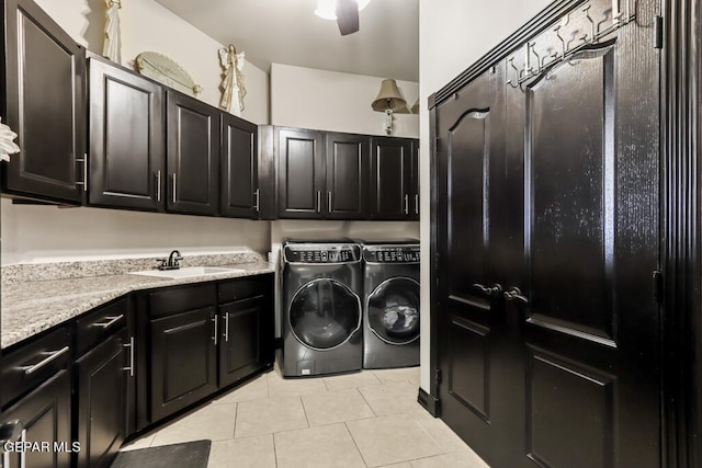 washroom featuring sink, washing machine and clothes dryer, light tile patterned flooring, ceiling fan, and cabinets