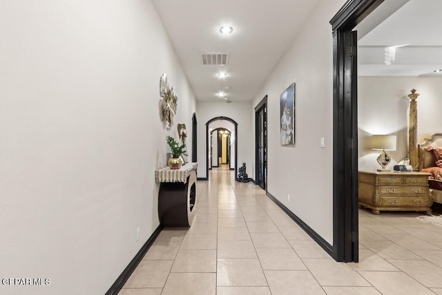 hall featuring light tile patterned floors