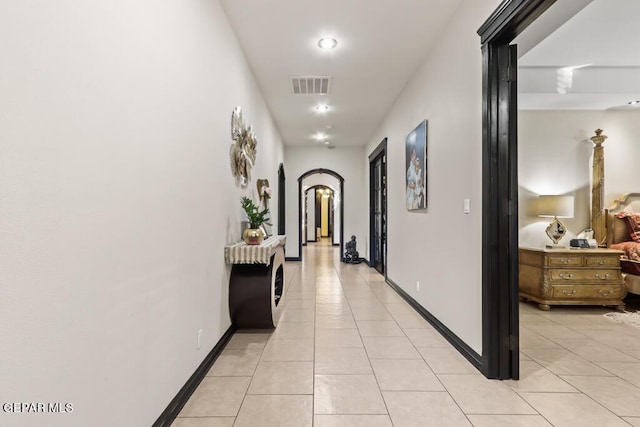 4500 Honey Willow Way, El Paso, TX 79922 - hall with arched walkways, light tile patterned flooring, baseboards, and recessed lighting