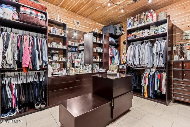 walk in closet with light tile patterned floors