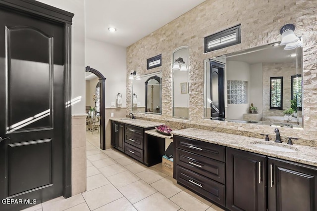 4500 Honey Willow Way, El Paso, TX 79922 - full bathroom with tile patterned floors, vanity, a wainscoted wall, and tile walls