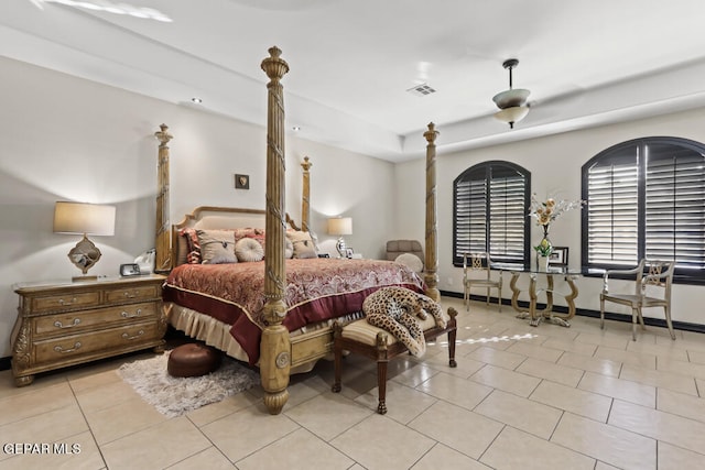 bedroom with ceiling fan and light tile patterned floors