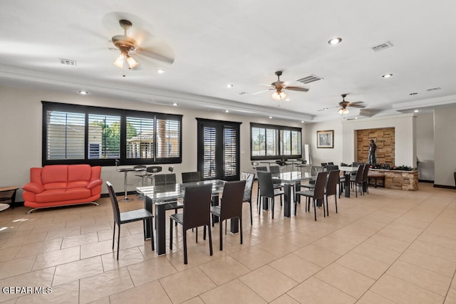 tiled dining room featuring ceiling fan and plenty of natural light