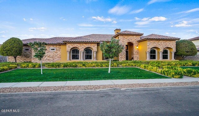 4500 Honey Willow Way, El Paso, TX 79922 - mediterranean / spanish house with a tile roof, stone siding, a front yard, and stucco siding