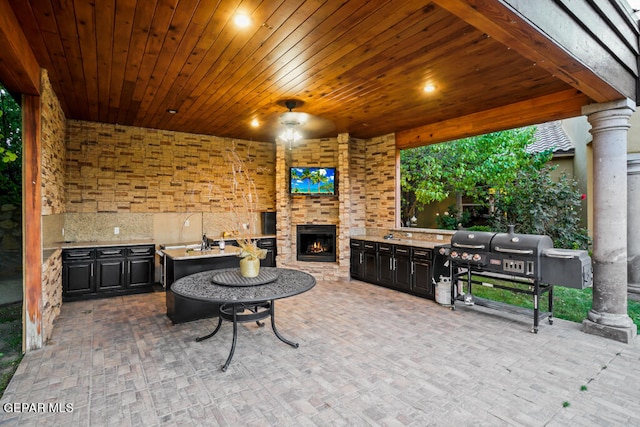 view of patio with grilling area and an outdoor kitchen