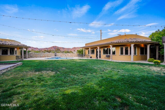 view of yard with a patio and a mountain view