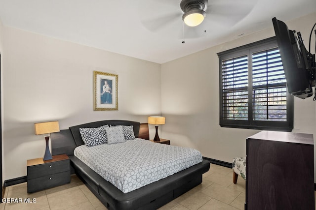 tiled bedroom featuring ceiling fan