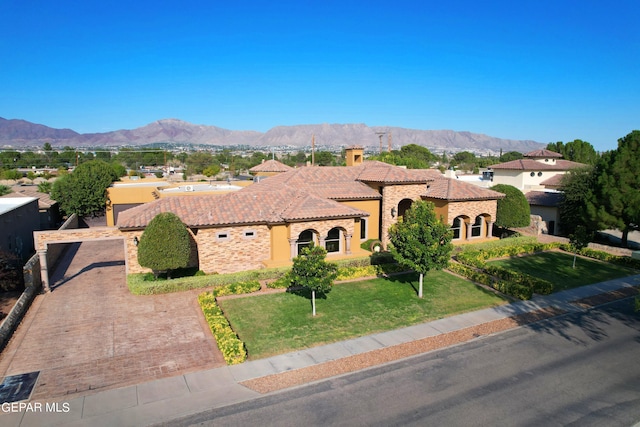 4500 Honey Willow Way, El Paso, TX 79922 - mediterranean / spanish home featuring a mountain view, a tiled roof, stucco siding, a front lawn, and decorative driveway