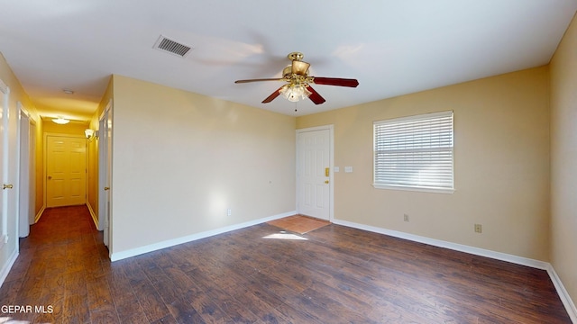 unfurnished room with ceiling fan and dark wood-type flooring