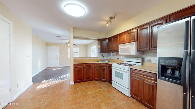 kitchen with backsplash, white appliances, ceiling fan, sink, and light tile patterned floors