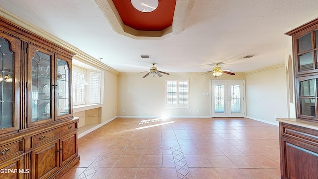 tiled living room with crown molding, french doors, ceiling fan, and a textured ceiling