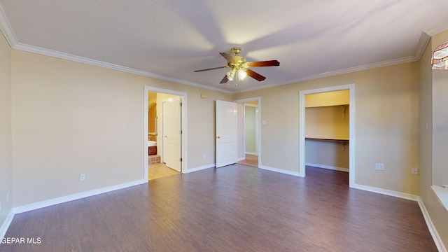 unfurnished bedroom with crown molding, ceiling fan, a spacious closet, wood-type flooring, and a closet