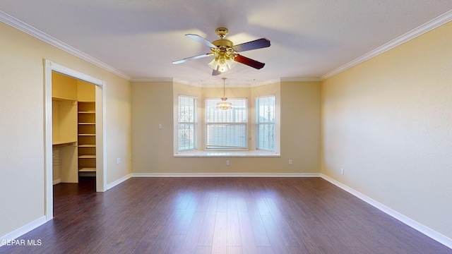 empty room with dark hardwood / wood-style floors, crown molding, and ceiling fan with notable chandelier