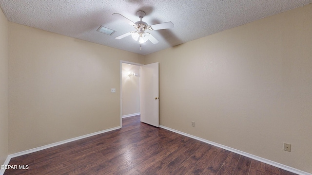 unfurnished room with a textured ceiling, ceiling fan, and dark wood-type flooring