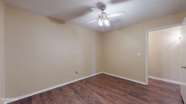 empty room featuring a textured ceiling, ceiling fan, and dark wood-type flooring