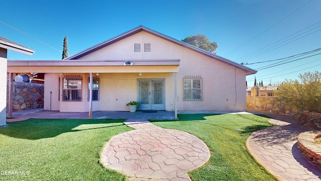 back of house featuring a patio area and a yard