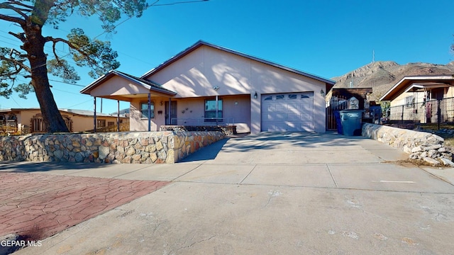 single story home with a mountain view and a garage