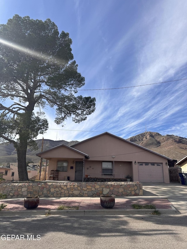 view of front of property featuring a mountain view and a garage