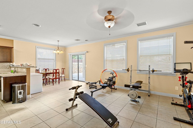 exercise area featuring light tile patterned floors, visible vents, baseboards, and crown molding