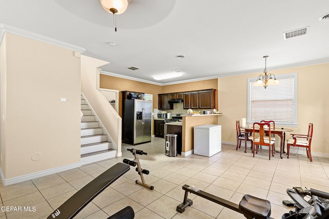 kitchen featuring visible vents, dark brown cabinets, stainless steel fridge with ice dispenser, ornamental molding, and light tile patterned flooring