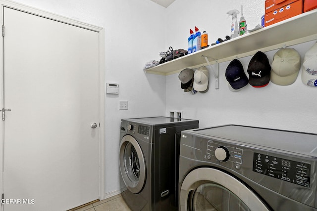 laundry area with light tile patterned floors, laundry area, and separate washer and dryer