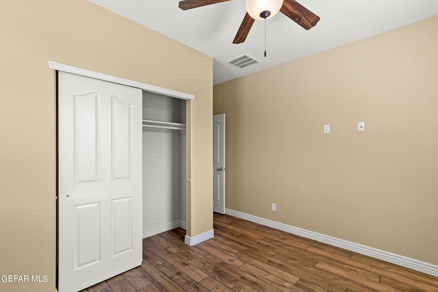 unfurnished bedroom with wood finished floors, visible vents, baseboards, ceiling fan, and a closet