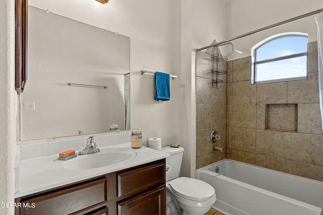 bathroom featuring toilet, shower / washtub combination, and vanity