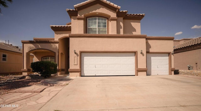 mediterranean / spanish house with a garage